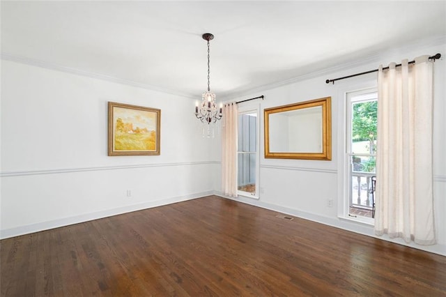 unfurnished room with dark hardwood / wood-style floors, an inviting chandelier, and ornamental molding