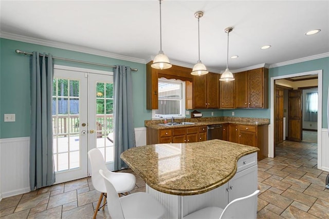 kitchen featuring a center island, french doors, sink, crown molding, and decorative light fixtures