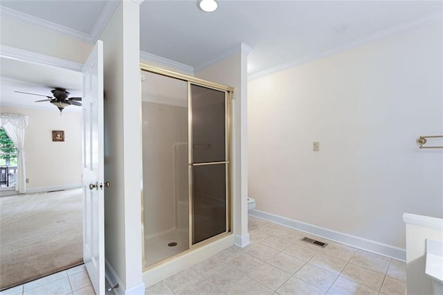 bathroom with crown molding, toilet, ceiling fan, and walk in shower