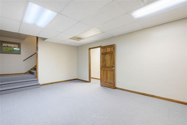 basement with carpet floors and a drop ceiling