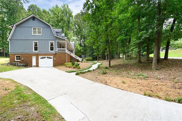 view of front of property featuring a garage and cooling unit