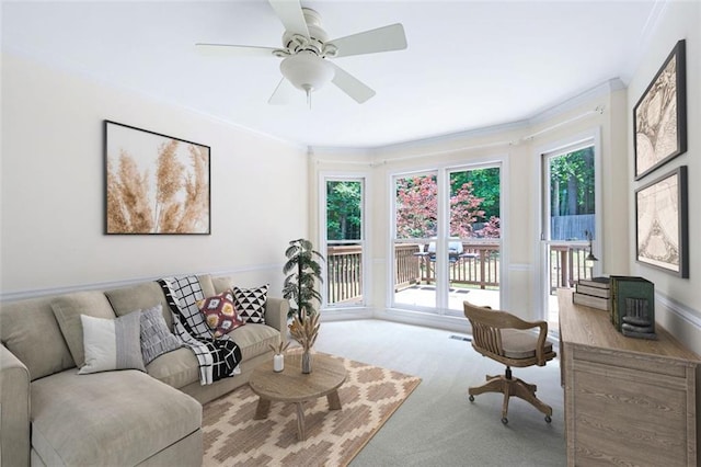 living room with light carpet, crown molding, and ceiling fan