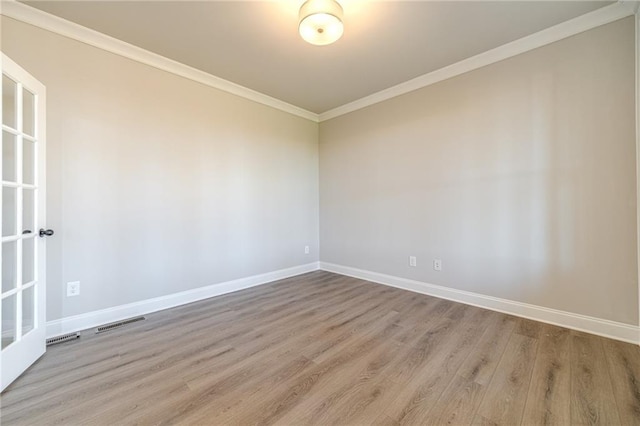 unfurnished room featuring crown molding and light hardwood / wood-style flooring