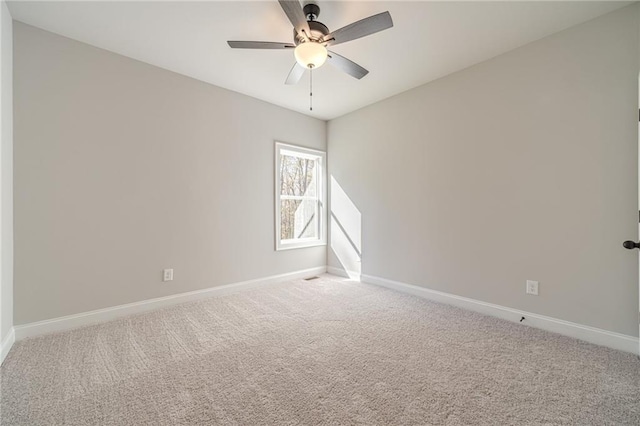 unfurnished room with ceiling fan and carpet floors