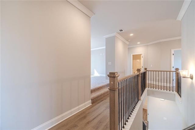 hall featuring light hardwood / wood-style floors and ornamental molding