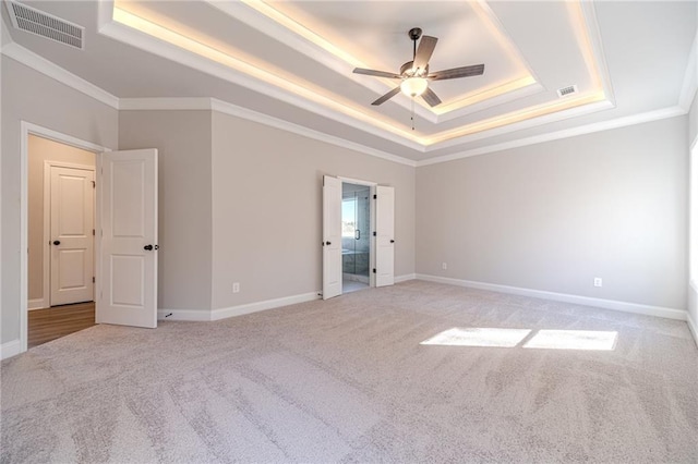 unfurnished room with carpet floors, a raised ceiling, and ceiling fan