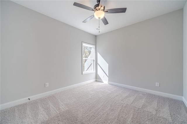 empty room featuring carpet floors and ceiling fan