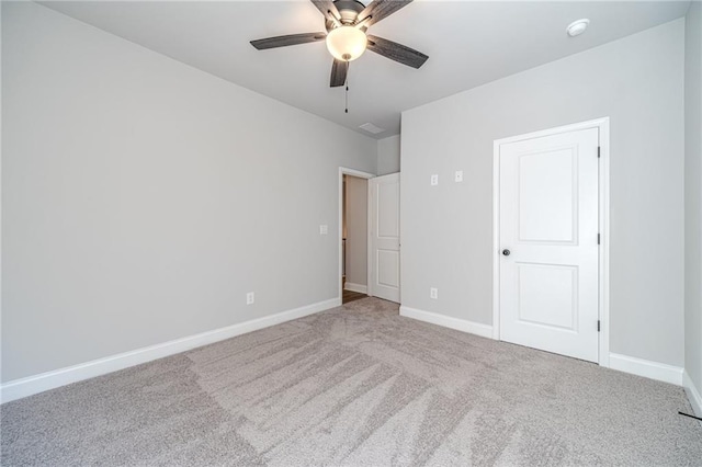 unfurnished bedroom featuring ceiling fan and carpet