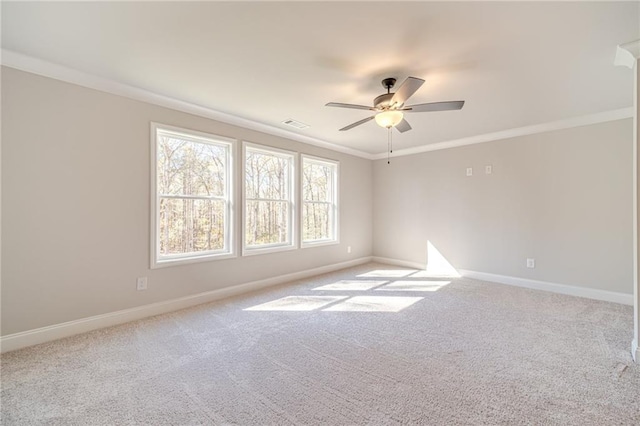 carpeted empty room featuring ceiling fan and ornamental molding