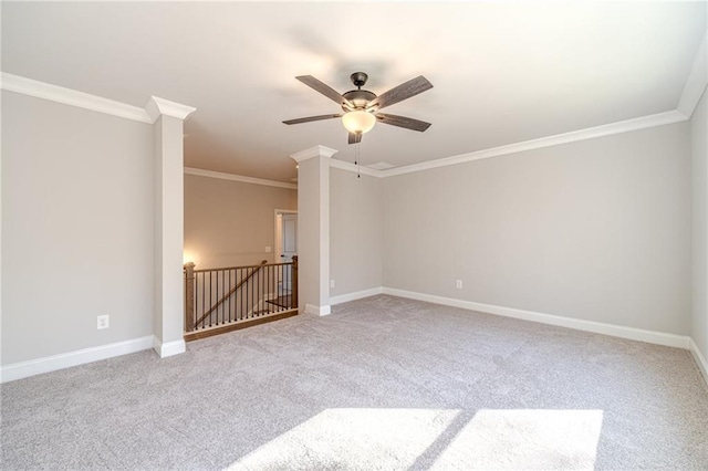 carpeted spare room featuring ceiling fan and crown molding