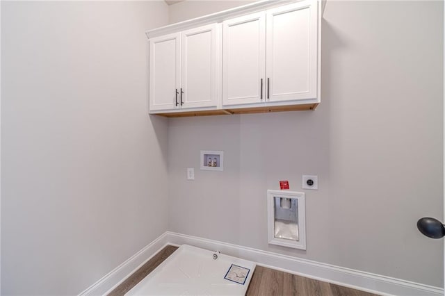 laundry area with cabinets, hookup for an electric dryer, hookup for a gas dryer, dark hardwood / wood-style floors, and hookup for a washing machine