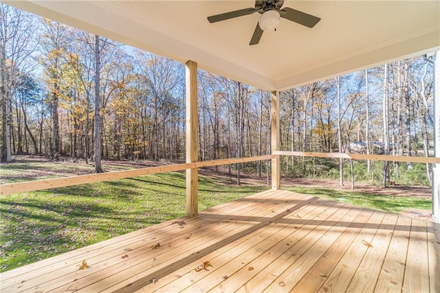 wooden terrace with ceiling fan and a yard