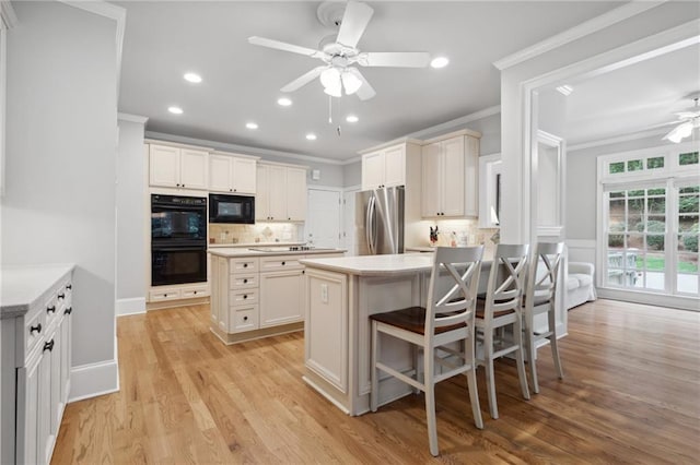 kitchen featuring backsplash, ceiling fan, ornamental molding, a peninsula, and black appliances