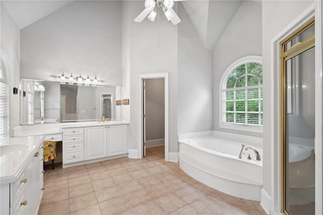 bathroom featuring high vaulted ceiling, a garden tub, vanity, and tile patterned flooring