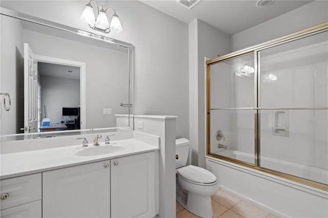 ensuite bathroom featuring vanity, ensuite bath, tile patterned floors, toilet, and combined bath / shower with glass door