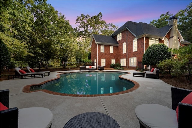 view of swimming pool featuring a fenced in pool, a patio, and fence