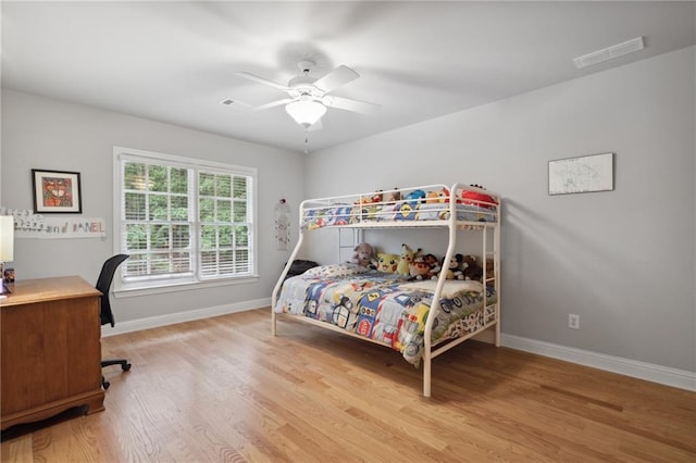 bedroom with a ceiling fan, baseboards, visible vents, and light wood-type flooring