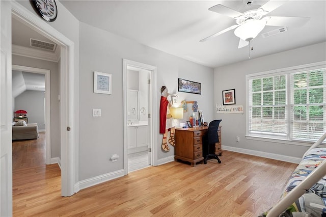 office space featuring baseboards, visible vents, light wood finished floors, and ceiling fan