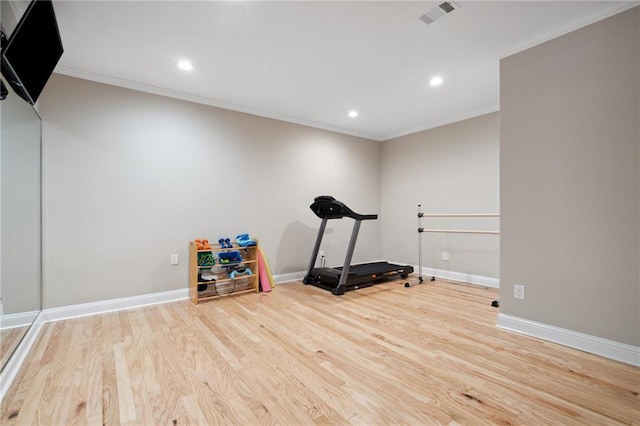 exercise room featuring recessed lighting, ornamental molding, baseboards, and wood finished floors