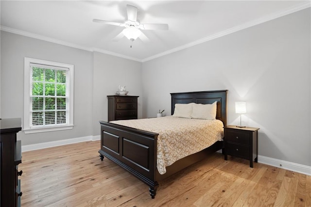 bedroom with crown molding, light wood-style flooring, a ceiling fan, and baseboards