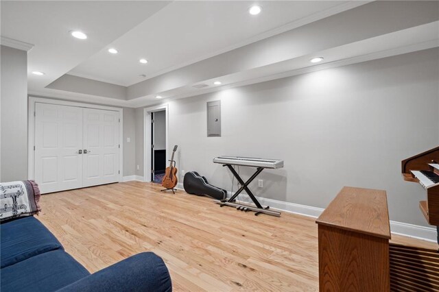 workout room with electric panel, recessed lighting, baseboards, and wood finished floors