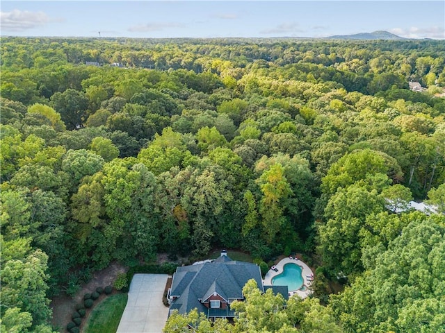 birds eye view of property featuring a view of trees