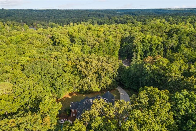 birds eye view of property featuring a view of trees