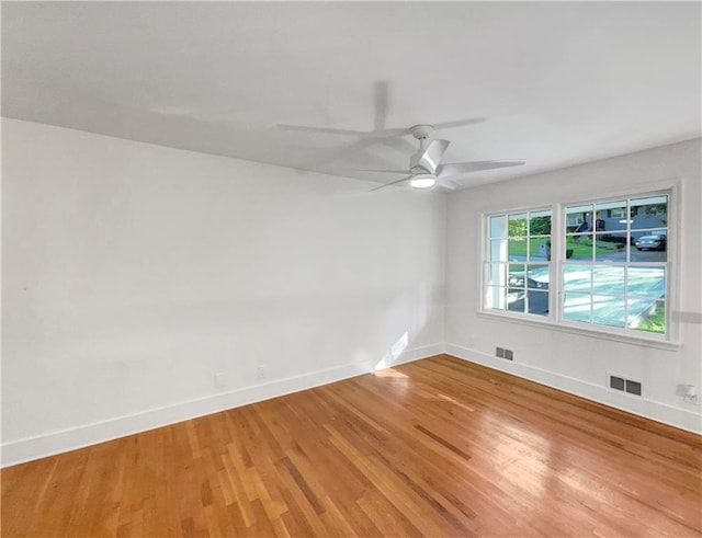 unfurnished room with hardwood / wood-style floors and ceiling fan