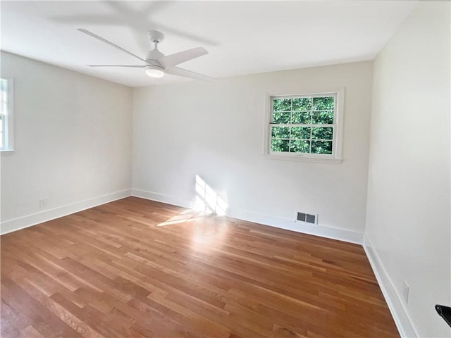 empty room with ceiling fan and hardwood / wood-style floors