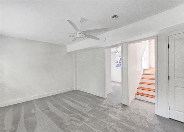 basement with ceiling fan and carpet flooring