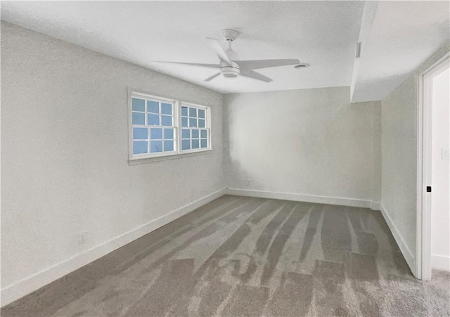 carpeted empty room with ceiling fan and a wealth of natural light