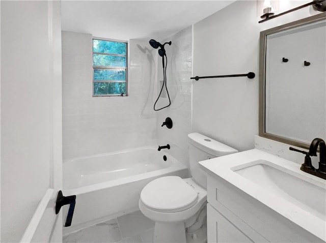 full bathroom with vanity, tiled shower / bath combo, and toilet