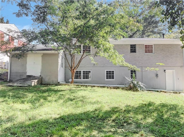 rear view of house featuring a lawn