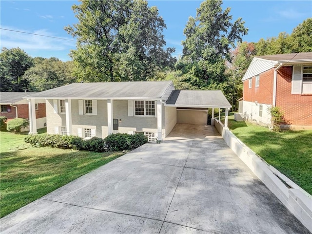 split foyer home featuring a front lawn and a carport