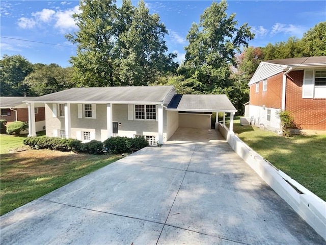 raised ranch featuring a carport and a front lawn