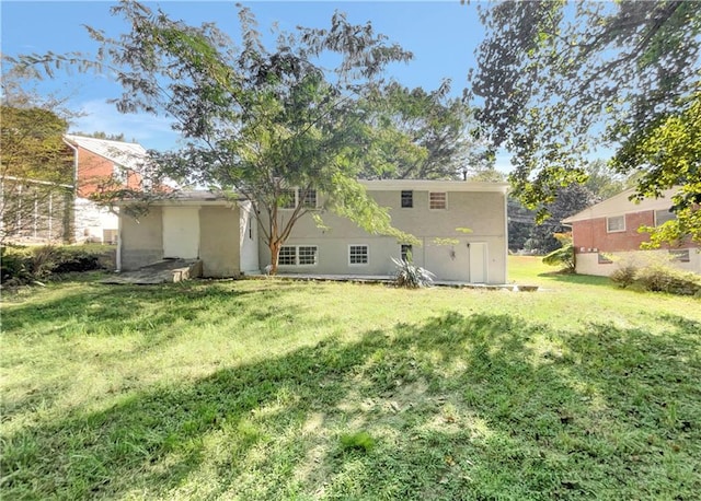 rear view of house featuring a lawn