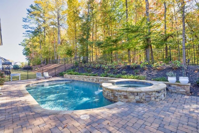 view of swimming pool with an in ground hot tub and a patio area