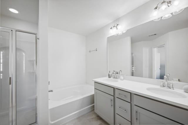 bathroom featuring separate shower and tub and vanity