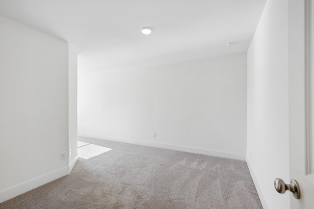 unfurnished room with light carpet