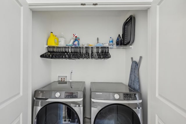 clothes washing area featuring independent washer and dryer