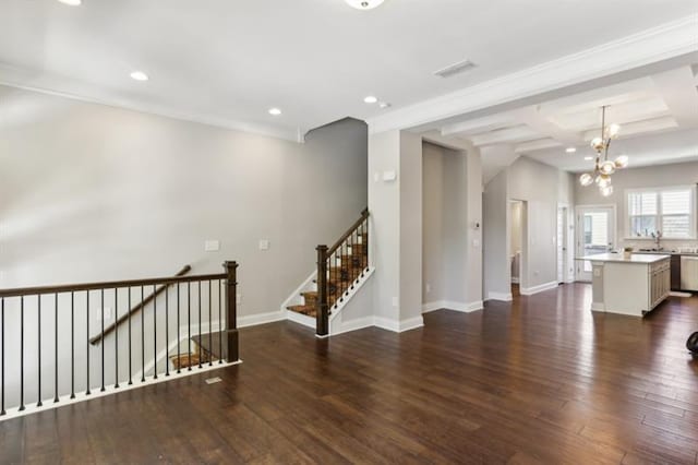 spare room with a chandelier, recessed lighting, dark wood-style flooring, and baseboards