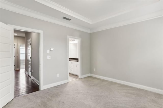 unfurnished bedroom with carpet, baseboards, visible vents, and crown molding