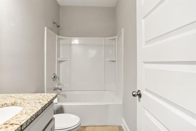 bathroom featuring toilet, shower / washtub combination, and vanity