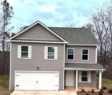 view of front of house featuring a garage, covered porch, and concrete driveway