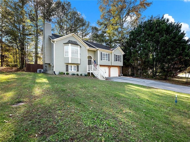 bi-level home with a front yard and a garage