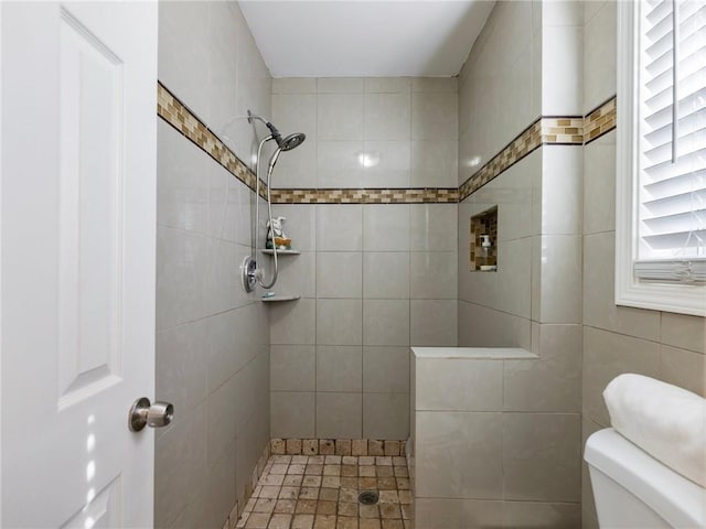 bathroom featuring tile walls and tiled shower