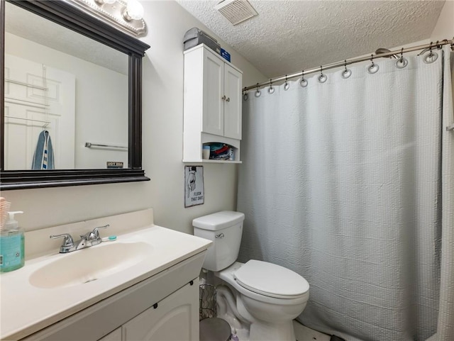 bathroom featuring a shower with curtain, vanity, a textured ceiling, and toilet