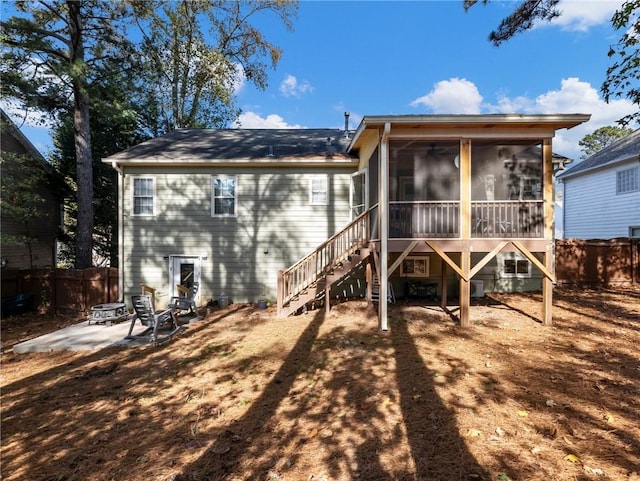 rear view of property featuring a patio area and a sunroom