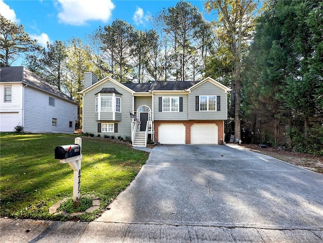 raised ranch with a front lawn and a garage