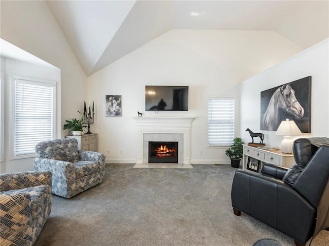 carpeted living room with plenty of natural light and lofted ceiling